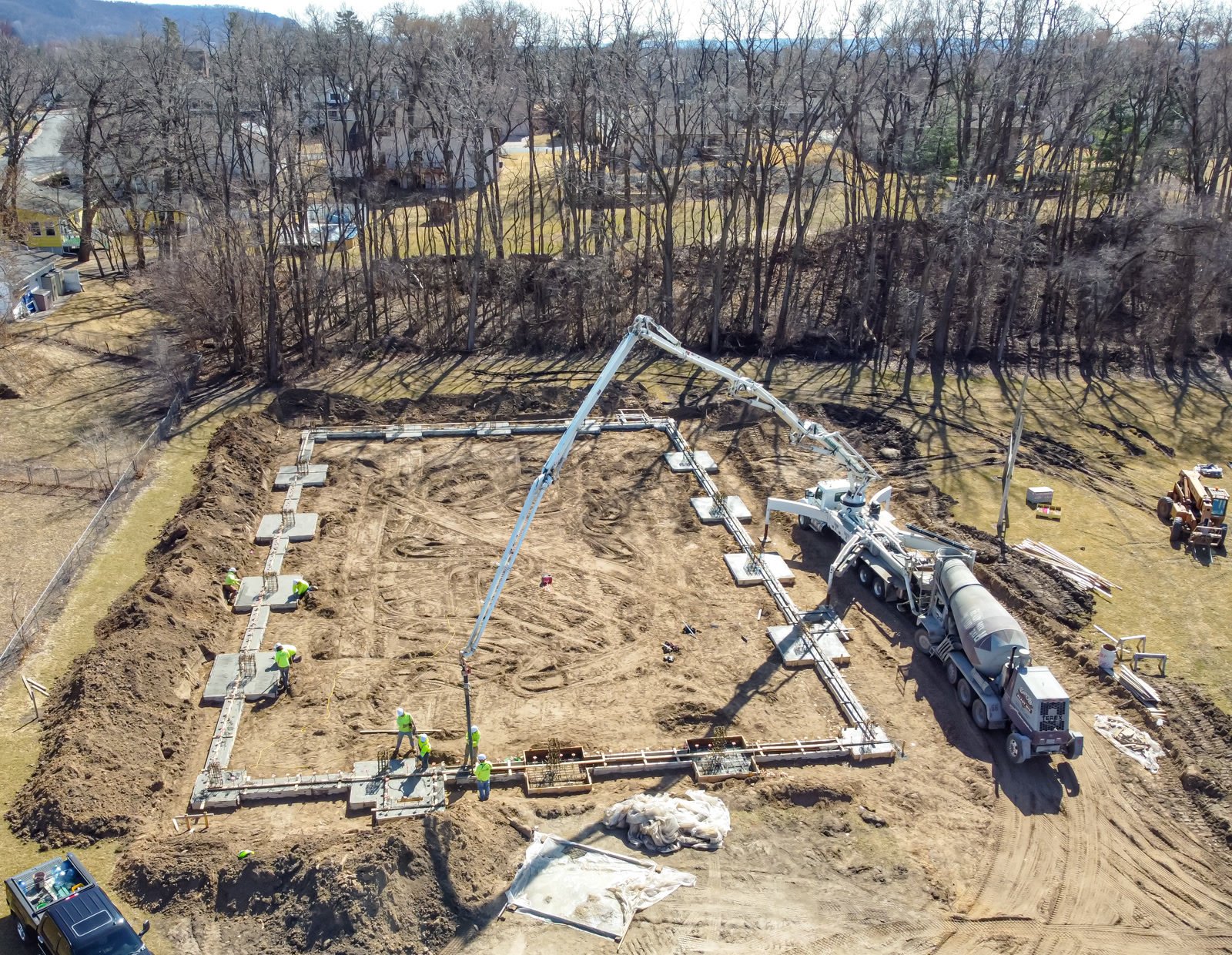 Aerial view of a concrete pump truck placing a foundation pour