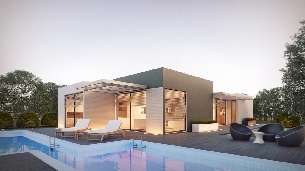 Modern single-story house with a swimming pool, sun loungers and an outdoor terrace at dusk