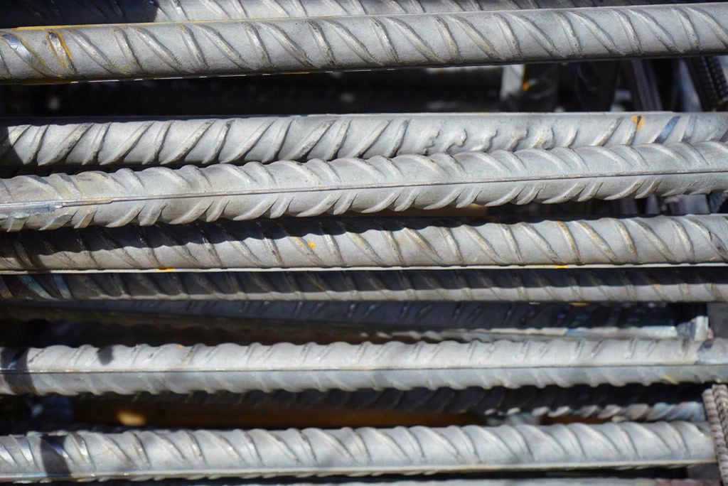 Close-up of stacked deformed steel reinforcing bars