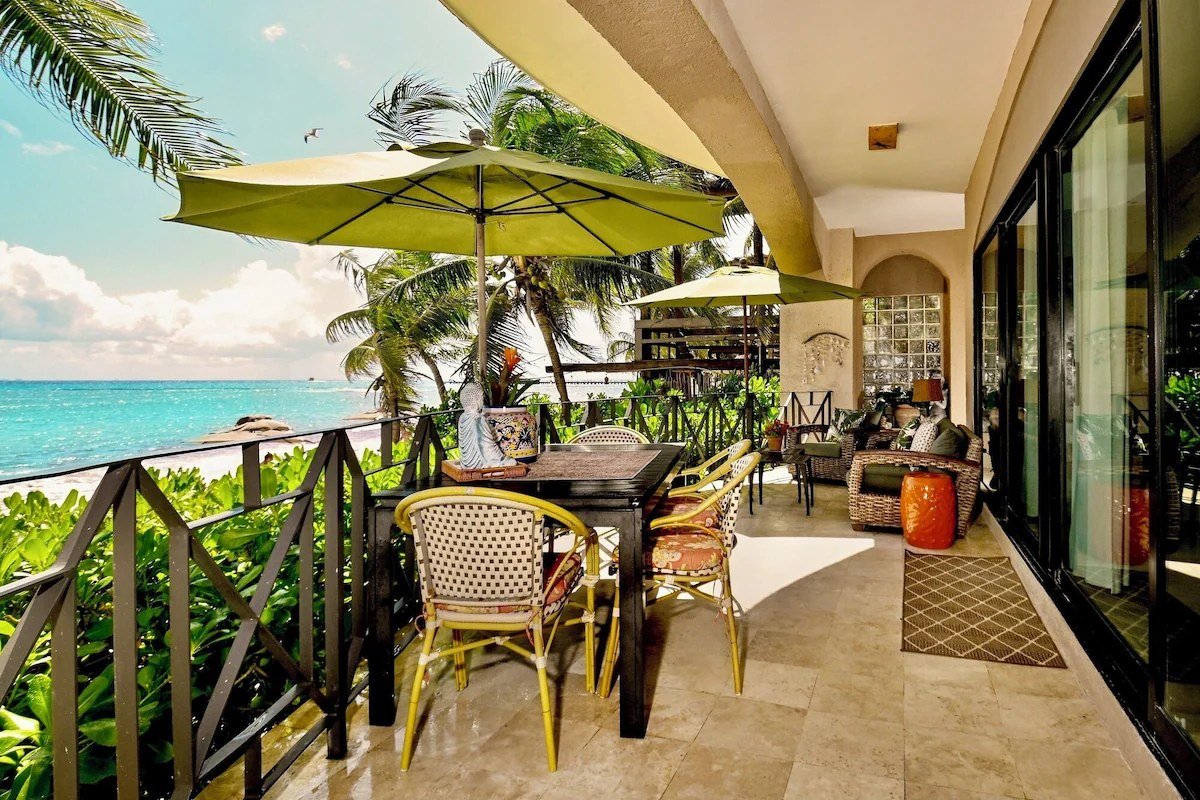 Beachfront terrace of a Playa del Carmen condo overlooking the Caribbean.